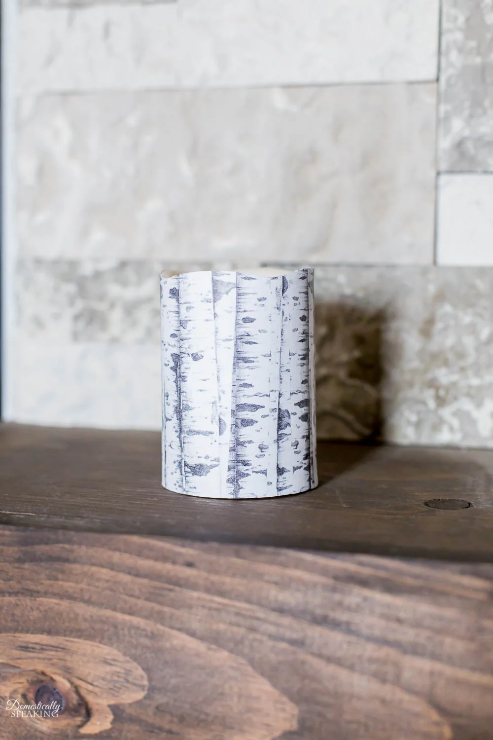 DIY Dollar Tree project.  A candle with decoupaged birchwood pattern attached.