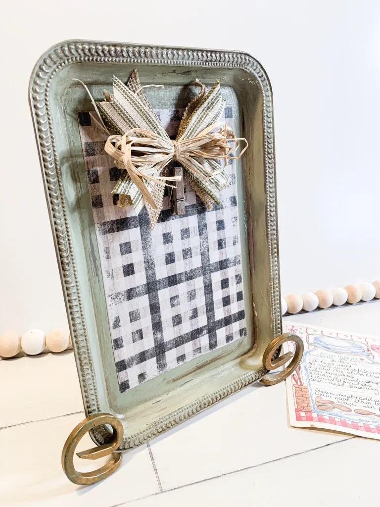 DIY Dollar Tree Craft using a silver tray, scrapbook paper and ribbon to make a recipe holder.